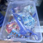 A CCR holding a bin of packaged snacks